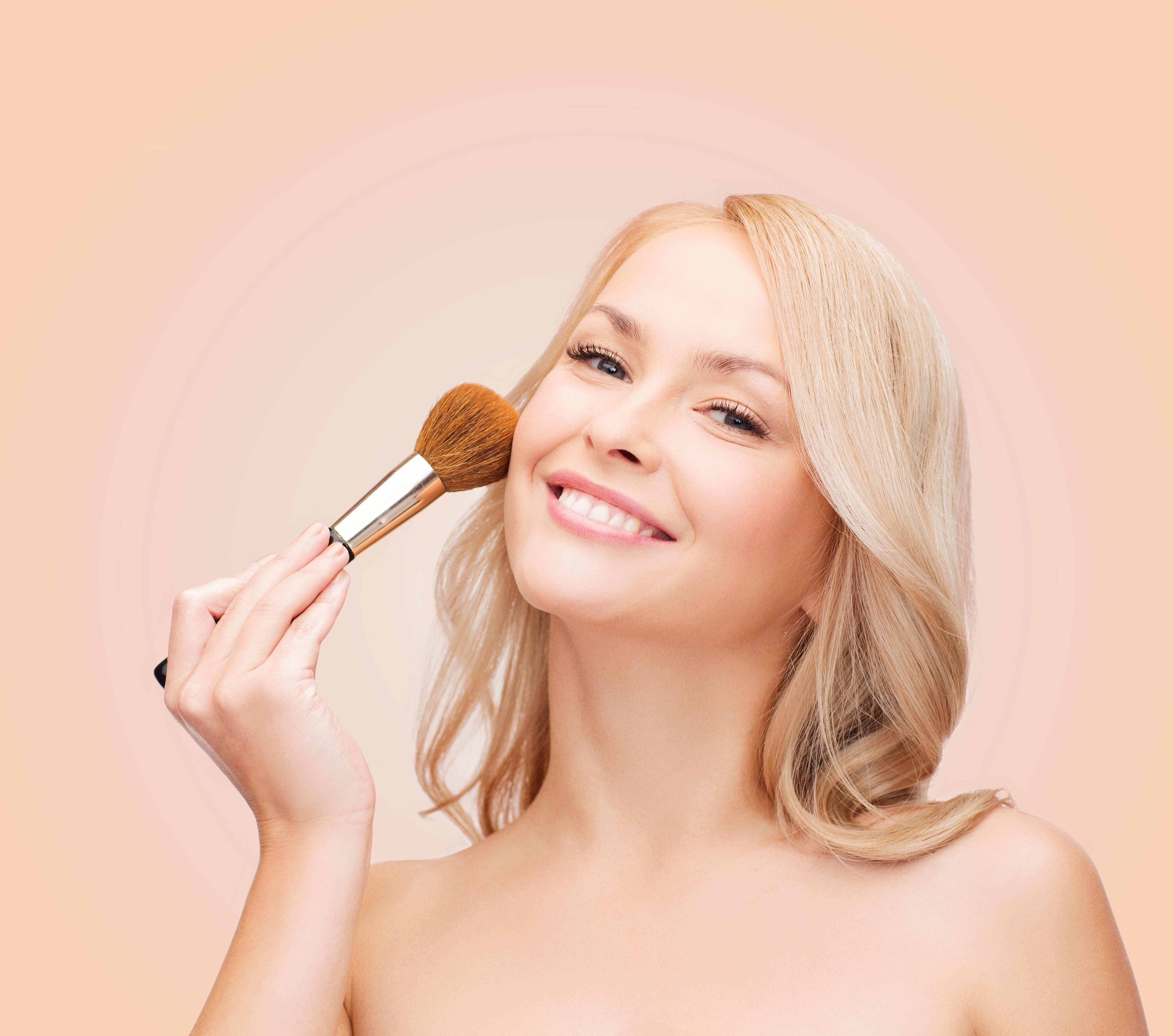 beautiful woman with closed eyes and makeup brush